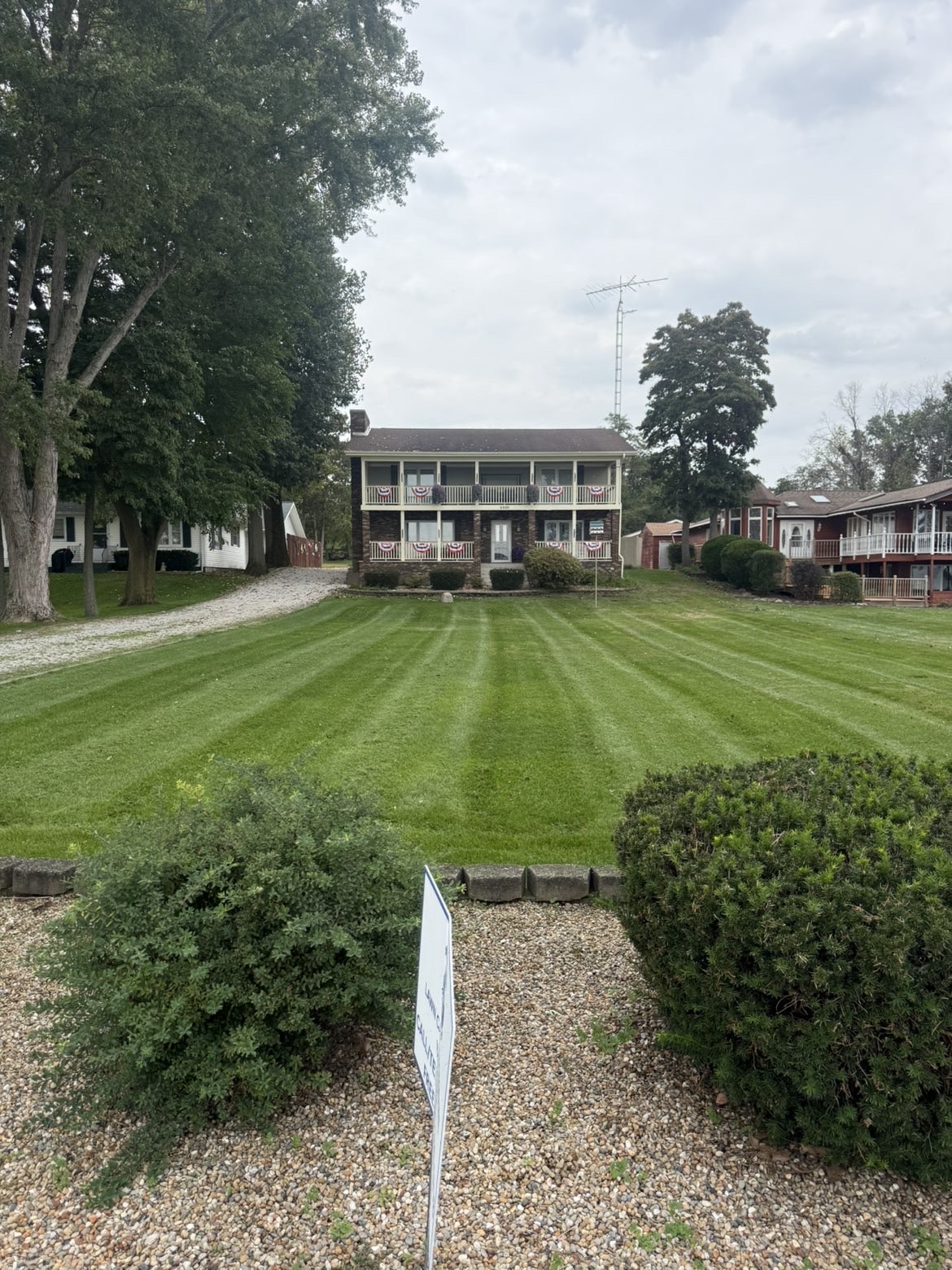 Striped front lawn with landscaped beds in front of a home